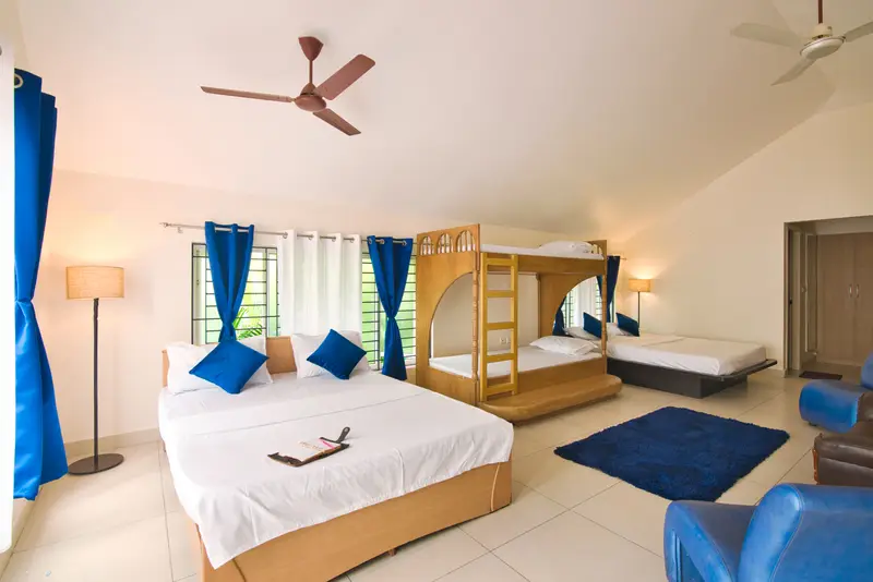 A room with a double bed and bunk beds — good for the kids